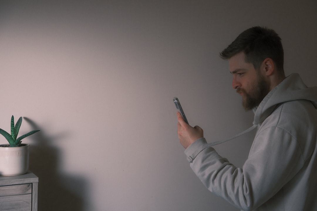 A creator filming casually on a phone in a well-lit kitchen, evidence of a streamlined, low-friction setup