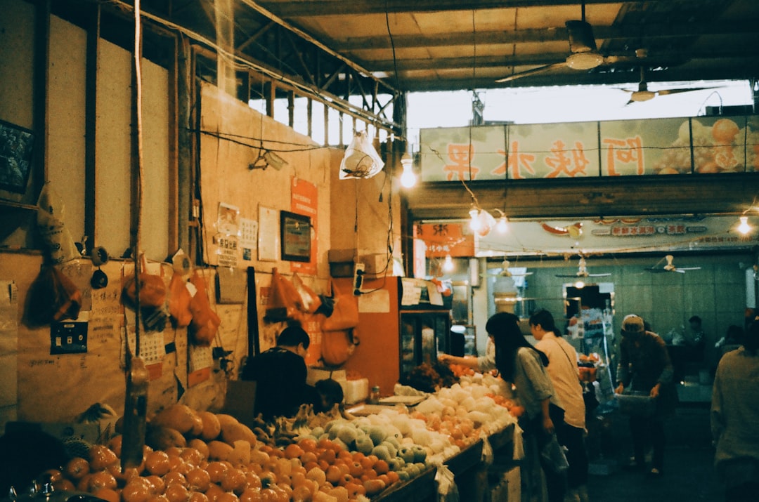 A travel vlogger exploring a local market, camera in hand, interacting with vendors